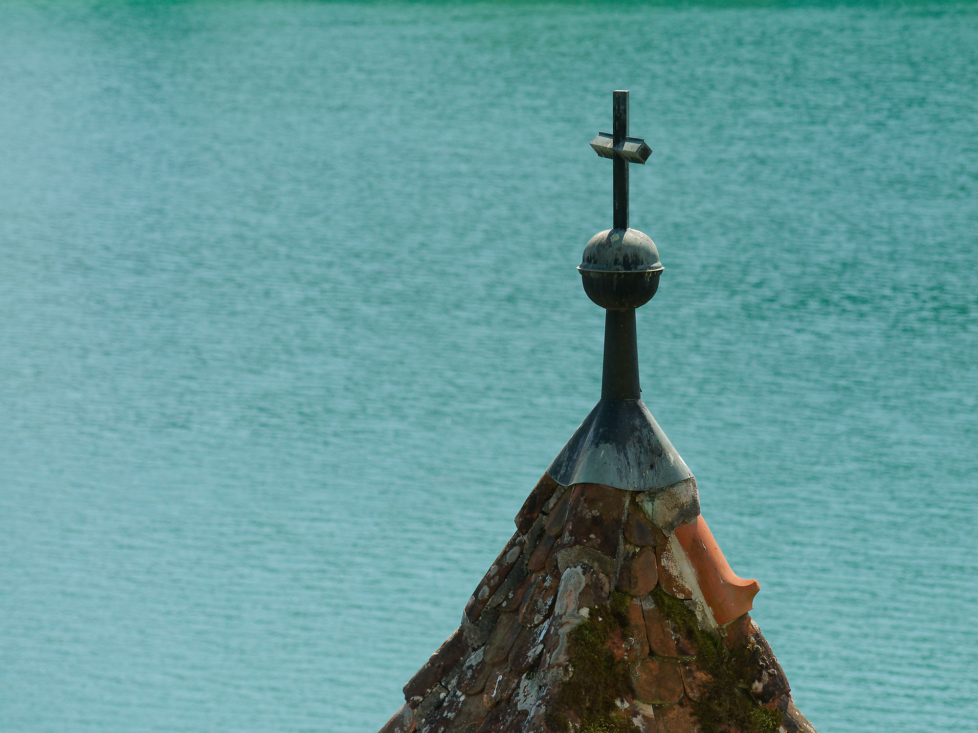 Kirchturmspitze mit Kreuz am Bleder See, Slowenien. Wahrzeichen, Reiseziel.